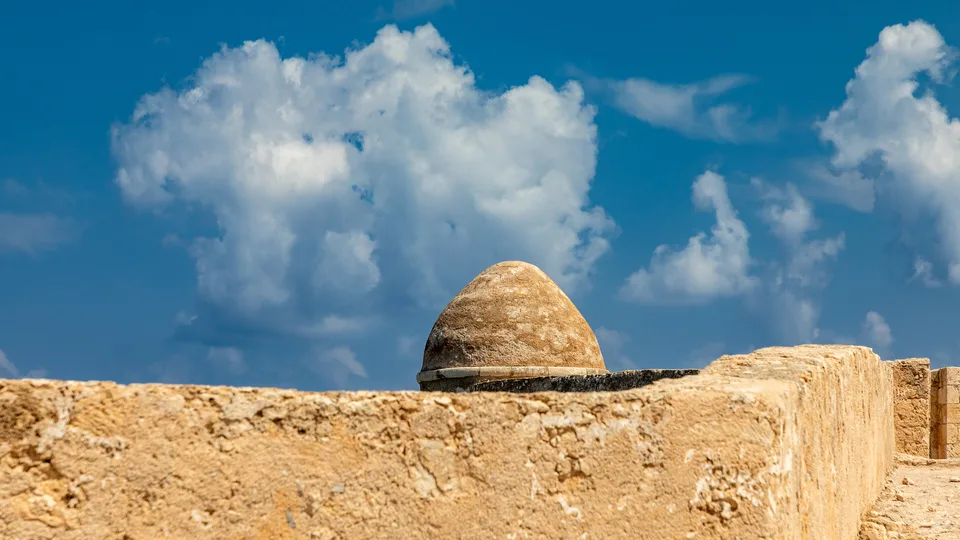 A sunlit stone fortress wall under a blue sky, the wallpaper of the day on a zTab homepage